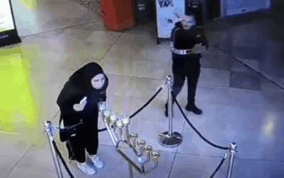 CCTV footage circulating on social media shows a woman extinguishing candles on a public Chanukah menorah inside the Weizmann Mall in Tel Aviv after hours.