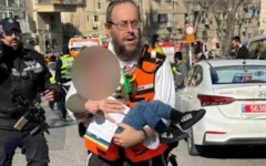 An injured child being carried after an incident at the daycare centre. Photo Credit: United Hatzalah