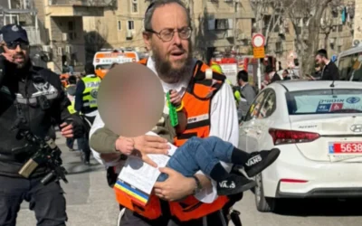 An injured child being carried after an incident at the daycare centre. Photo Credit: United Hatzalah