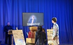 Students perform alongside recorded testimony of Holocaust survivor and Windermere Child Harry Olmer during the Holocaust Memorial Day tribute at the Royal Ballet School.