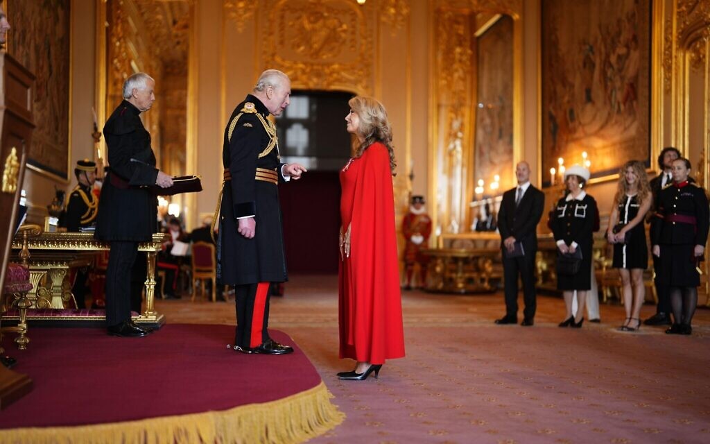 King Charles presenting Tracy-Ann Oberman with her MBE, awarded for  services to holocaust education and combating antisemitism.
