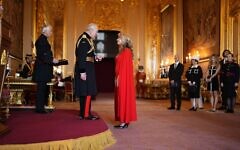 King Charles presenting Tracy-Ann Oberman with her MBE, awarded for  services to holocaust education and combating antisemitism.