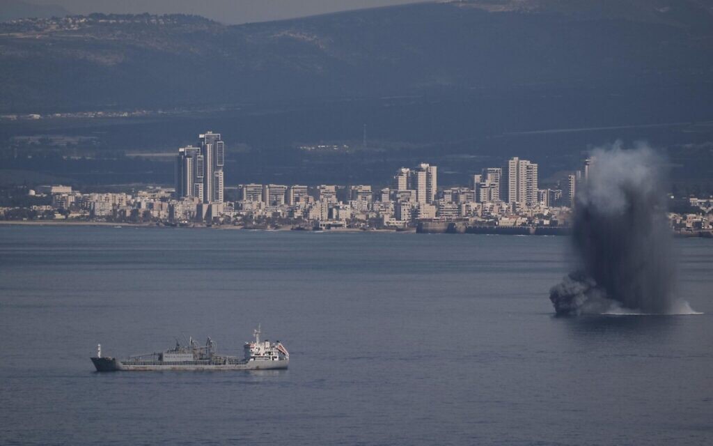 An incoming projectile explodes over the water as Israel issues a nationwide alert following its strikes on Iran, in Haifa Bay, northern Israel, Saturday, Feb. 28, 2026. (AP Photo/Leo Correa)