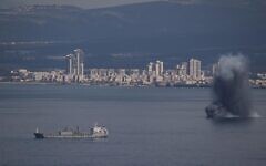 An incoming projectile explodes over the water as Israel issues a nationwide alert following its strikes on Iran, in Haifa Bay, northern Israel, Saturday, Feb. 28, 2026. (AP Photo/Leo Correa)