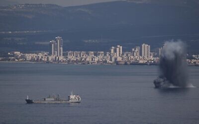 An incoming projectile explodes over the water as Israel issues a nationwide alert following its strikes on Iran, in Haifa Bay, northern Israel, Saturday, Feb. 28, 2026. (AP Photo/Leo Correa)