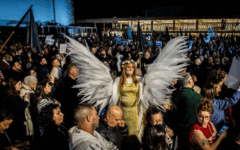 A woman wearing wings stands above the crowd during a protest rally in Tel Aviv on Saturday Jan 31 2026. Tens of thousands of Arab and Jewish protesters turned out in Tel Aviv Saturday night for a massive rally, accusing the government of neglecting its Arab citizens and allowing violence to run rampant in the community. Photo by Eyal Warshavsky