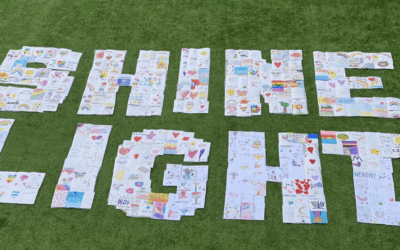 Handwritten cards of care arranged to spell ‘Shine Light’, reflecting the message behind a UK-led initiative supporting hostages, wounded soldiers and bereaved families in Israel.