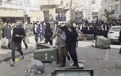 Police escort two female IDF soldiers to safety as ultra-Orthodox rioters chase them through the streets of Bnei Brak during unrest over conscription. Credit: Video via X / David Keshet