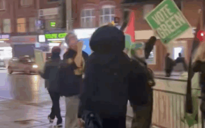 Green supporters wave Palestinian flags on the streets of Gorton and Denton