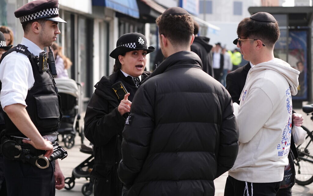 Police officers speaking to local residents in Golders Green, London, after an apparent arson attack on four ambulances belonging to the Jewish Community Ambulance service in London. The Metropolitan Police confirmed the incident is being treated as an antisemitic hate crime. Picture date: Monday March 23, 2026. PA Photo. Photo credit should read: Jonathan Brady/PA Wire