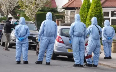 Police officers search on Brookside Road at the junction with Russell Gardens near to the scene in Highfield Road, Golders Green, London, after an apparent arson attack on four ambulances belonging to the Jewish Community Ambulance service in London.  Pic PA