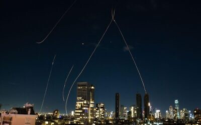 This long exposure photo taken on Feb. 28, 2026 shows flare trails of the interceptor missiles launched from Israeli air defense systems