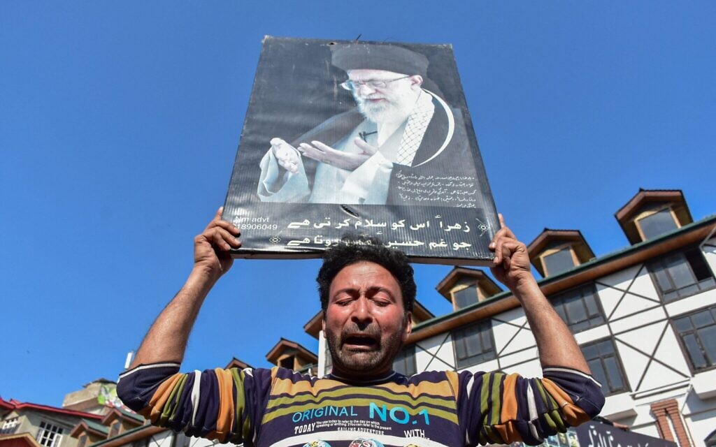 A Kashmiri Shiite Muslim mourns as he holds a photograph of the deceased Iranian Supreme Leader Ayatollah Ali Khamenei during a protest against the U.S. and Israel.