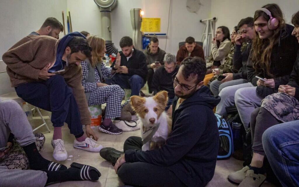 Israelis take cover in a public shelter in Tel Aviv as a siren sounds warning of incoming ballistic missiles fired from Iran toward Israel, March 1, 2026. (Chaim Goldberg/Flash90)