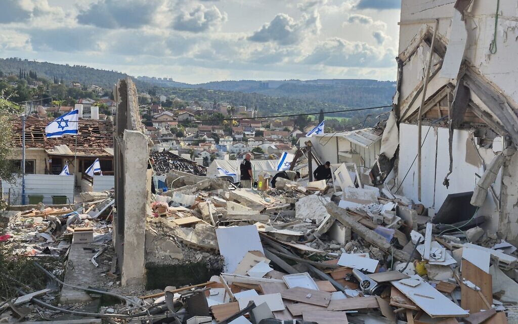 Rescuers search through the rubble of homes destroyed by an Iranian missile strike in Beit Shemesh that killed nine people. Photo Credit: Jewish Agency for Israel