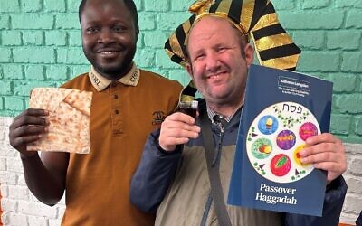 Kisharon Langdon member, David (R), with support worker, Sodiq, using the Haggadah at a mock seder.