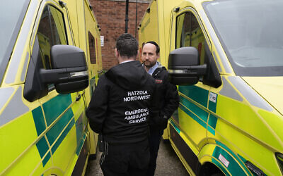 Staff from Hatzola Northwest Emergency Ambulance Service stand alongside the four replacement ambulances, which are on loan from the London Ambulance Service (LAS), at the the Jewish Community Ambulance service in Golders Green, London. Four ambulances belonging to Jewish charity Hatzola were set on fire in the early hours of Monday, with dramatic footage showing gas cannisters that were stored in the vehicles exploding. Picture date: Tuesday March 24, 2026. PA Photo. Photo credit should read: Stefan Rousseau/PA Wire