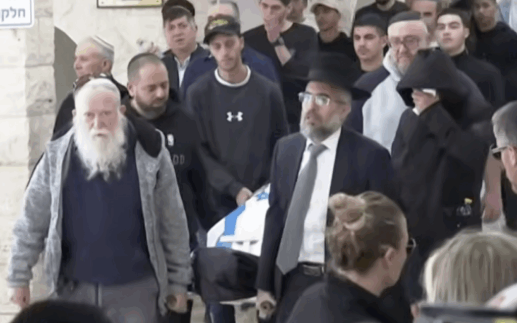 Mourners carry the flag-draped coffin of Oren Katz during his funeral in Beit Shemesh following an Iranian missile strike.
