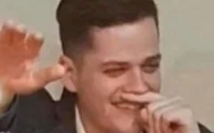 Image appearing to show Corey Edwards mimicking a Nazi salute and Adolf Hitler-style moustache.