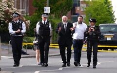 Metropolitan Police Commissioner Sir Mark Rowley (second left) and Chief Rabbi Sir Ephraim Mirvis (third right) at the scene in Golders Green, north-west London, after two men - one aged in his 70s and another in his 30s - were stabbed on Wednesday morning. The Metropolitan Police said a 45-year-old man was arrested and remains in custody. Picture date: Wednesday April 29, 2026.