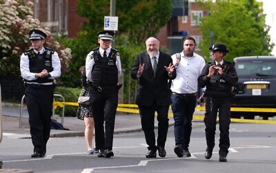 Metropolitan Police Commissioner Sir Mark Rowley (second left) and Chief Rabbi Sir Ephraim Mirvis (third right) at the scene in Golders Green, north-west London, after two men - one aged in his 70s and another in his 30s - were stabbed on Wednesday morning. The Metropolitan Police said a 45-year-old man was arrested and remains in custody. Picture date: Wednesday April 29, 2026.