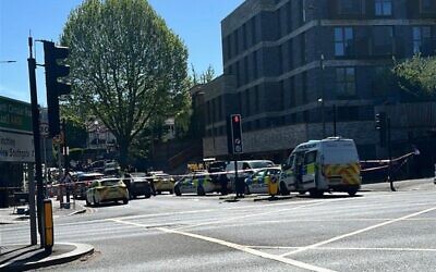 Police cordons and emergency vehicles on Golders Green Road following a stabbing incident in which two people were injured and a suspect was arrested. Credit: X
