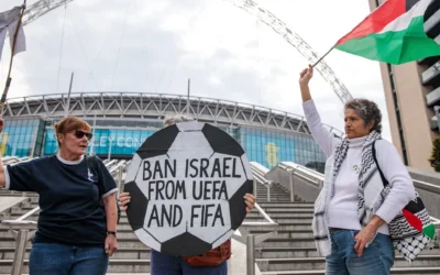 Pro-Palestinian activists protest with a football-shaped sign and a Palestinian flag outside Wembley Stadium to demand that the Football Association issue a public statement calling for the Israeli Football Association (IFA) to be suspended from participation in UEFA and FIFA tournaments, on October 2, 2025 in London, United Kingdom. (Mark Kerrison/In Pictures via Getty Images via JTA)