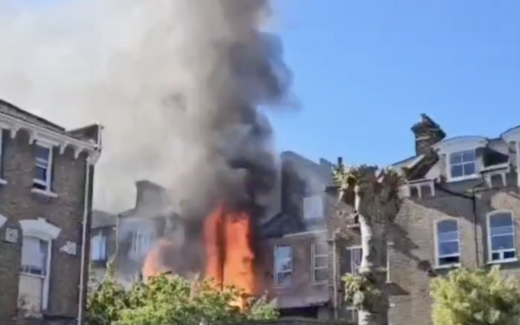 Flames rise from a building beside a synagogue on Cazenove Road in Stamford Hill as emergency crews respond to the blaze on Thursday afternoon. Photo credit: The Yeshiva World News / X screenshot