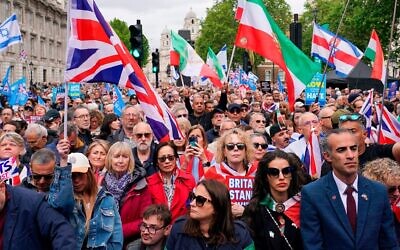 Demonstrators gather holding flags and placards as they attend a protest against antisemitism and extremism, in London, Sunday, May 10, 2026.(AP Photo/Alberto Pezzali)
