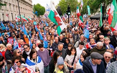Demonstrators gather holding flags and placards as they attend a protest against antisemitism and extremism, in London, Sunday, May 10, 2026.(AP Photo/Alberto Pezzali)