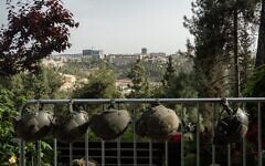IDF soldiers' helmets are hung from a rail, with Jerusalem in the background, on Israel's Memorial Day on April 30, 2025 in Jerusalem, Israel. (Ori Aviram / Middle East Images / Middle East Images via AFP via JTA) IDF soldiers' helmets are hung from a rail, with Jerusalem in the background, on Israel's Memorial Day on April 30, 2025 in Jerusalem, Israel. (Ori Aviram / Middle East Images / Middle East Images via AFP via JTA)