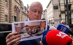 US ambassador to Belgium Bill White shows an image of a ritual circumcision, as he arrives for a meeting at the offices of the Foreign Affairs department of the Federal Government in Brussels on Feb. 17, 2026. (Marius Burgelman / BELGA MAG / Belga via AFP)