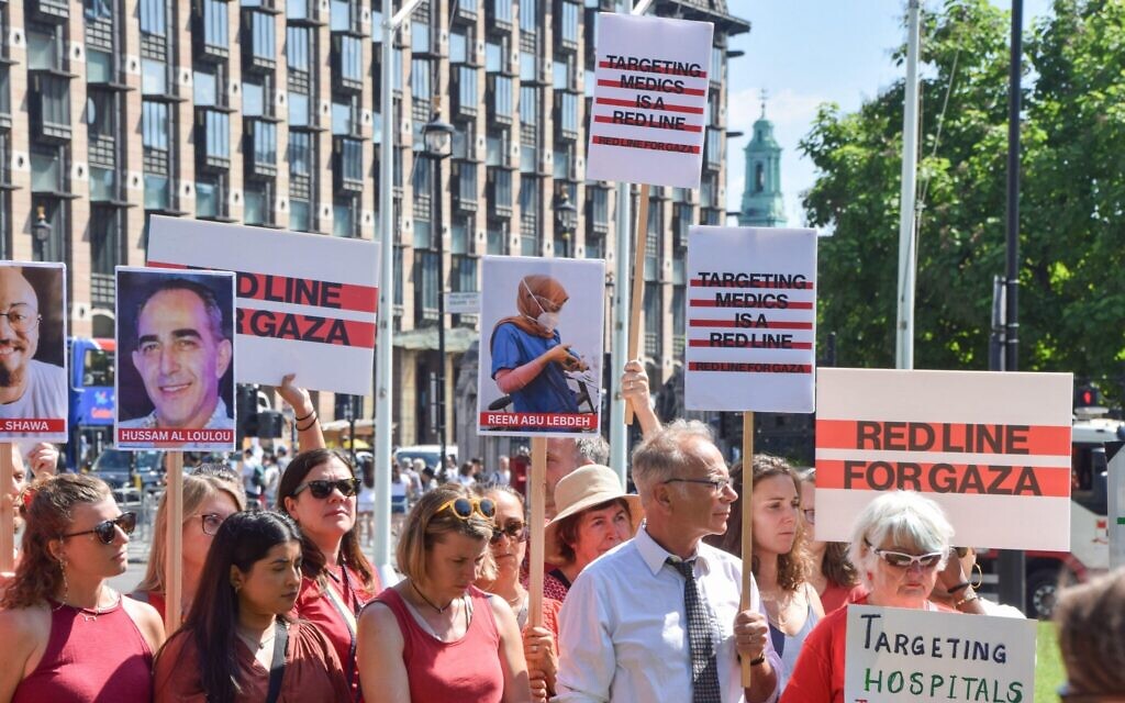 Protesters, including doctors and members of the British Medical Association (BMA), gather in Parliament Square for a 'Red Line' demonstration against Israeli forces targeting hospitals, doctors and medical staff in Gaza