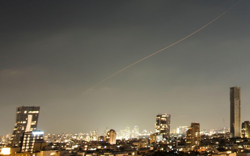 A projectile streaks through the sky over central Israel during an Iranian missile attack, Sunday, June 7, 2026. (AP Photo/Ohad Zwigenberg)