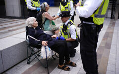 A police officer detains Reverend Sue Parfitt who declared her support for Palestine Action outside the headquarters of the Metropolitan Police at New Scotland Yard, central London, to mark one-year of the group being proscribed as a terror organisation. A police officer detains Reverend Sue Parfitt who declared her support for Palestine Action outside the headquarters of the Metropolitan Police at New Scotland Yard, central London, to mark one-year of the group being proscribed as a terror organisation.