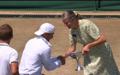Guy Sasson is presented with Wimbledon 2026 trophy