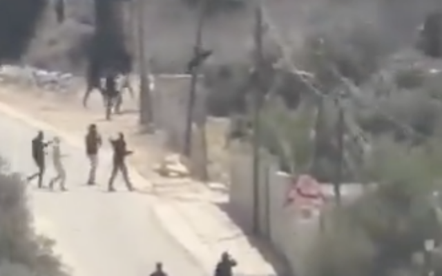 Palestinians and armed Israeli civilians during the confrontation near Tel in Samaria. Photo: X