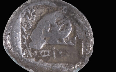 The rare 2,500-year-old Persian-period coin discovered on Ashdod beach, believed to be the first of its type found in Israel. Photo Credit: Shay Halevi/Israel Antiquities Authority