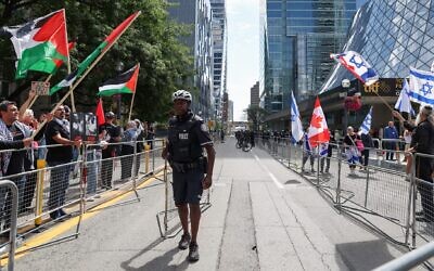 Pro-Palestinian and pro-Israel demonstrators rally on opposite sides of the street in front of the Roy Thompson Hall, where the documentary “The Road Between Us: The Ultimate Rescue” is showing, during the Toronto International Film Festival (TIFF) in Toronto, Ontario, Canada, on September 10, 2025. (Photo by Valerie Macon/ AFP)