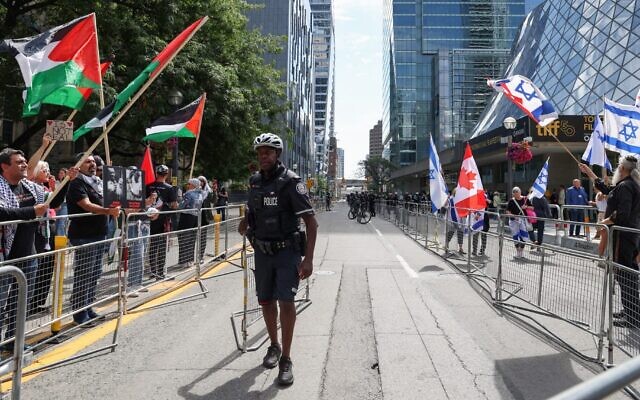 Pro-Palestinian and pro-Israel demonstrators rally on opposite sides of the street in front of the Roy Thompson Hall, where the documentary “The Road Between Us: The Ultimate Rescue” is showing, during the Toronto International Film Festival (TIFF) in Toronto, Ontario, Canada, on September 10, 2025. (Photo by Valerie Macon/ AFP)