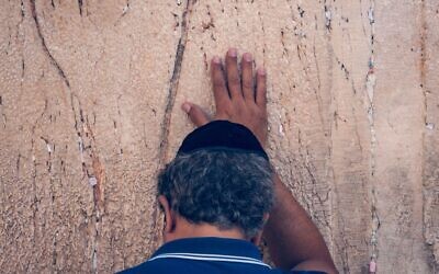 Jewish man praying with emotion at the the Western Wall.