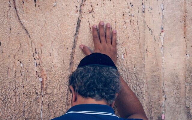 Jewish man praying with emotion at the the Western Wall.