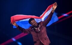 Dutch singer Claude Kiambe parades during the flag ceremony prior to the grand final of the Eurovision Song Contest 2025 at the St. Jakobshalle arena in Basel, May 17, 2025. (Fabrice COFFRINI / AFP via JTA)