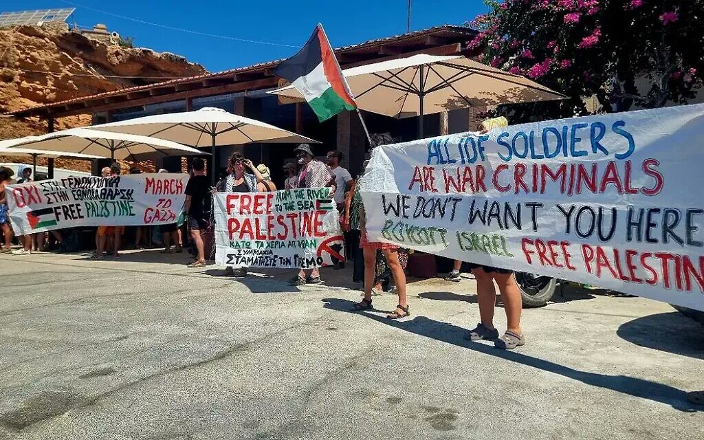 Pro-Palestinian protesters hold banners targeting Israeli tourists in Greece. Photo Credit: Combat Antisemitism Movement/X