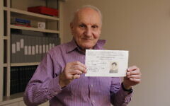 Harry Heber holds his original registration document from the 1930s. Photo Credit: World Jewish Relief Harry Heber holds his original registration document from the 1930s. Photo Credit: World Jewish Relief