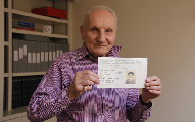 Harry Heber holds his original registration document from the 1930s. Photo Credit: World Jewish Relief