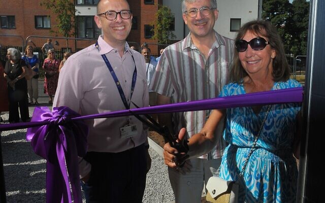 Marcia Brown cuts the ribbon to open LJHA’s new affordable homes development, watched by the association’s Director of Operations Craig Simons (left) and Chair of the Board Andrew Pliener