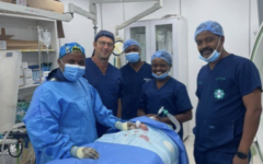 Dr. Sagi Assa (second from left), Senior Paediatric Cardiologist and Head of the Interventional Paediatric Cardiology Unit at Save a Child's Heart, poses with interventional paediatric cardiologist Dr. Gerard Misago, paediatric cardiac anesthesiologist Dr. Christine Niyibogora, and other members of the cardiac team from King Faisal Hospital in Rwanda following the successful life-saving procedure on the critically ill newborn. Dr. Sagi Assa (second from left), Senior Paediatric Cardiologist and Head of the Interventional Paediatric Cardiology Unit at Save a Child's Heart, poses with interventional paediatric cardiologist Dr. Gerard Misago, paediatric cardiac anesthesiologist Dr. Christine Niyibogora, and other members of the cardiac team from King Faisal Hospital in Rwanda following the successful life-saving procedure on the critically ill newborn.
