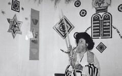 A Hasidic man performs the mitzvah of the Four Species inside a sukkah in Jerusalem, 1959. Photo credit - Avraham Malevsky, KKL-JNF Photo Archive A Hasidic man performs the mitzvah of the Four Species inside a sukkah in Jerusalem, 1959. Photo credit - Avraham Malevsky, KKL-JNF Photo Archive
