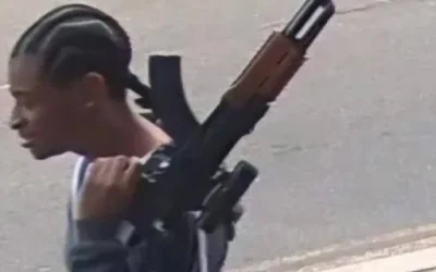 A man carrying what appeared to be a firearm in Edgware before a 22-year-old was arrested in connection with the incident. (Credit: X)